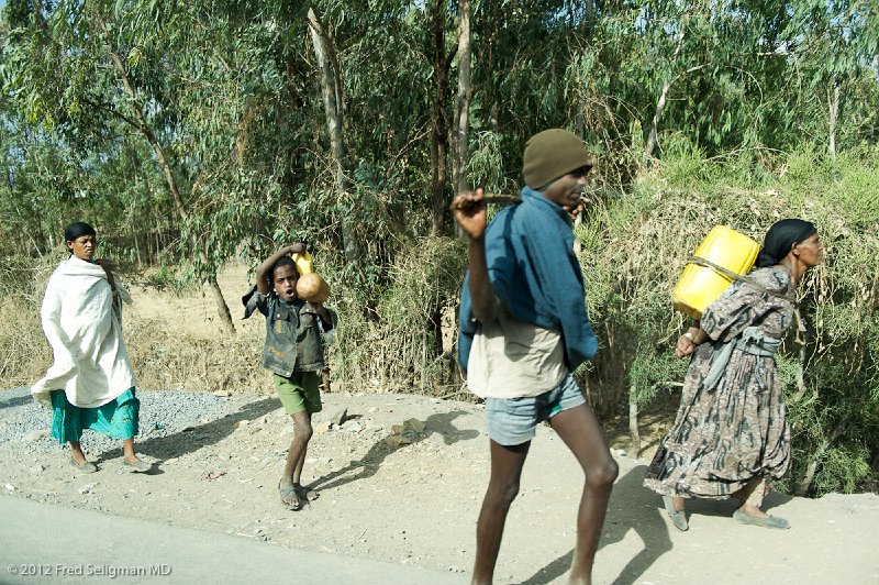 20120401_161016 Nikon D3S (1) 2x3.jpg - Carrying water.  Note the position of the carrying stick behind the neck